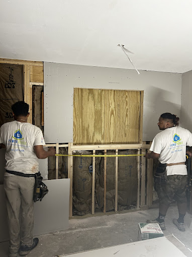 A couple of men standing next to each other in a room