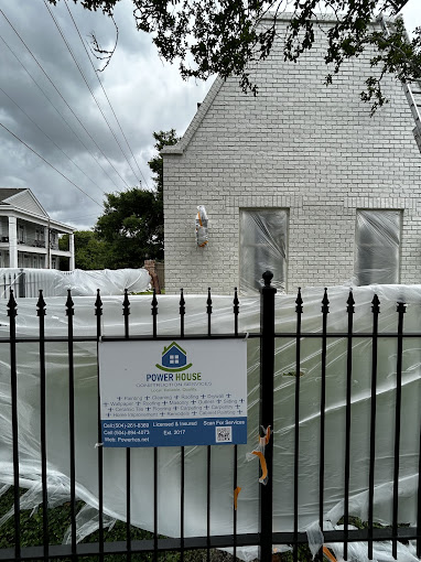 A house with a tarp covering the front of it